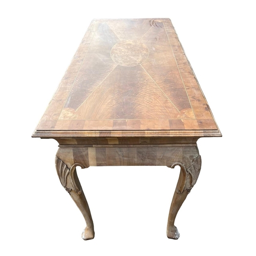 232 - MANNER OF DAVID LINLEY, A GEORGE II DESIGN WALNUT AND OYSTER VENEERED SERVING TABLE
The inlay top ra... 