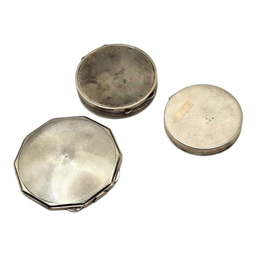 41 - THREE 20TH CENTURY ART DECO SILVER COMPACTS, ALL HAVING ENGINE TURNED DECORATIONS
Comprising a circu... 