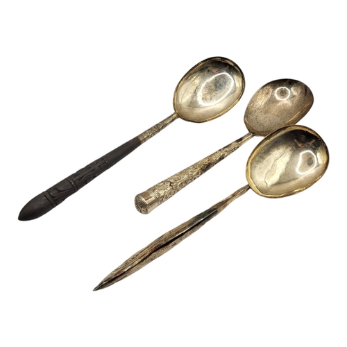 227 - THREE 20TH CENTURY ASIAN SILVER SERVING SPOONS
All having a variation of chased and engraved scrolli... 