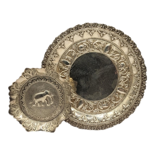 229 - TWO 20TH CENTURY CEYLON/SRI LANKA WHITE METAL DISHES (WHITE METAL TESTS AS SILVER)
Having chased and... 