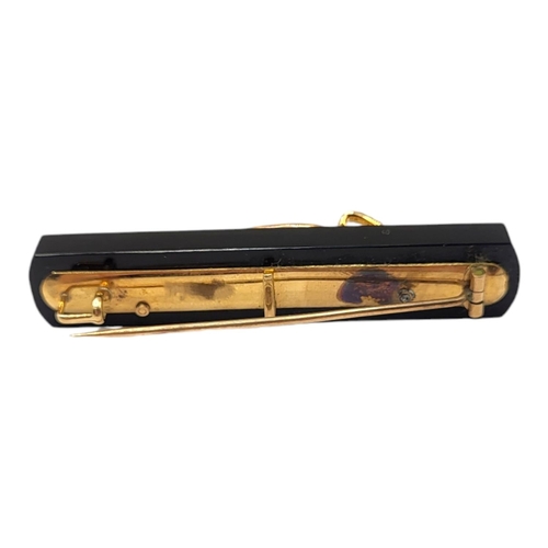 74 - A VICTORIAN YELLOW METAL, ONYX AND PEARL BROOCH, YELLOW METAL TESTED AS 9CT GOLDFront having stylis... 