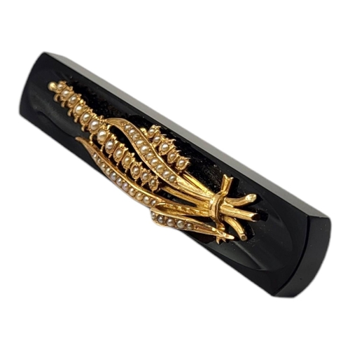 74 - A VICTORIAN YELLOW METAL, ONYX AND PEARL BROOCH, YELLOW METAL TESTED AS 9CT GOLDFront having stylis... 