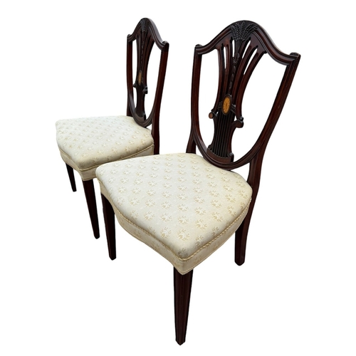 2 - A PAIR OF GEORGE III CARVED MAHOGANY AND INLAID SHIELD BACK SIDE CHAIRS
With upholstered seats, rais... 