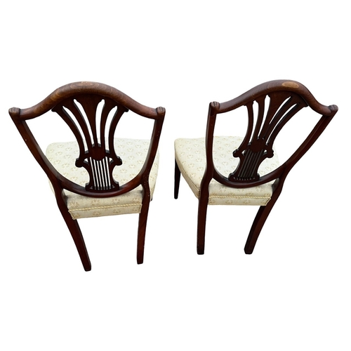 2 - A PAIR OF GEORGE III CARVED MAHOGANY AND INLAID SHIELD BACK SIDE CHAIRS
With upholstered seats, rais... 