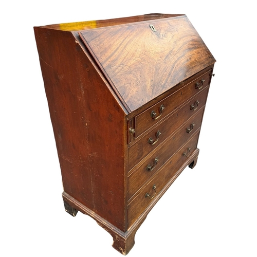 14 - A GEORGE III MAHOGANY BUREAU 
The hinged top opening to reveal fitted interior above four long gradu... 