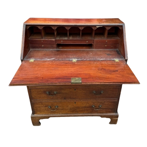 14 - A GEORGE III MAHOGANY BUREAU 
The hinged top opening to reveal fitted interior above four long gradu... 