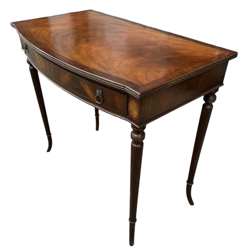 16 - A REGENCY DESIGN MAHOGANY AND INLAY SIDE TABLE
The bow front top above a single drawer, raised on fo... 