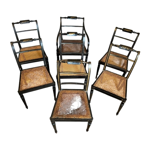 32 - A SET OF SEVEN REGENCY PAINTED CANE SEATED CHAIRS
Stamped to underside.