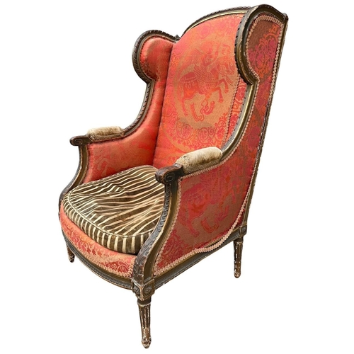 36 - AN EARLY 19TH CENTURY FRENCH CARVED GILTWOOD AND UPHOLSTERED WINGBACK ARMCHAIR
The shaped back above... 