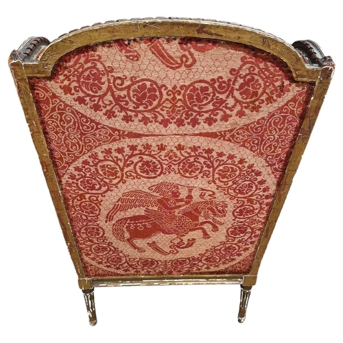 36 - AN EARLY 19TH CENTURY FRENCH CARVED GILTWOOD AND UPHOLSTERED WINGBACK ARMCHAIR
The shaped back above... 