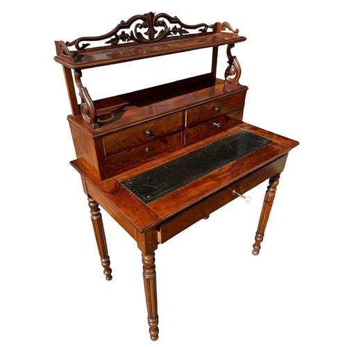 40 - A 19TH CENTURY VICTORIAN FLAME MAHOGANY LADIES’ WRITING TABLE
With scrolling and pieced gallery abov... 