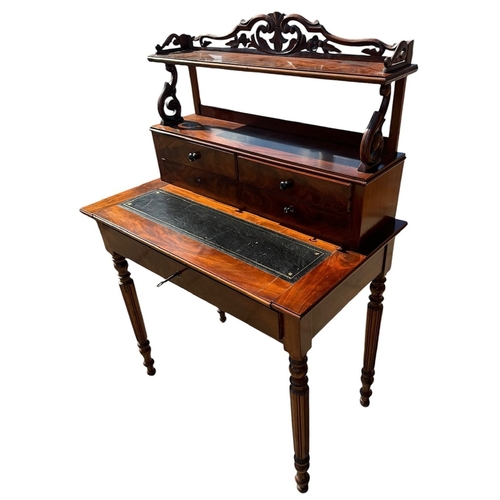 40 - A 19TH CENTURY VICTORIAN FLAME MAHOGANY LADIES’ WRITING TABLE
With scrolling and pieced gallery abov... 