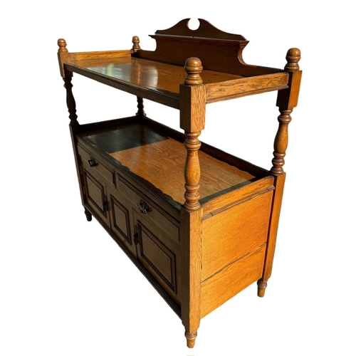 42 - A LATE 19TH CENTURY OAK TWO TIER BUFFET
With two drawers above a pair of doors, raised on turned leg... 