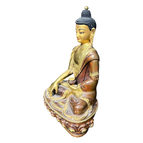 116 - A BRONZE AND GILT FIGURE OF SHAKYAMUNI. 
(h 20cm x w 13.5cm x d 9cm)