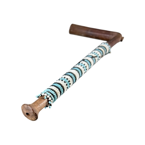 120 - A SOUTH AFRICAN ZULU SMOKING PIPE
Decorated with coloured glass beads. 
(length 30.2cm)