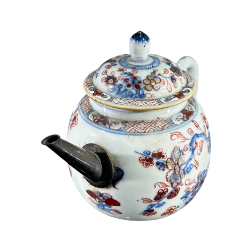 124 - A 19TH CENTURY CHINESE EXPORT TEAPOT
Having white metal spout, body decorated with floral foliage in... 