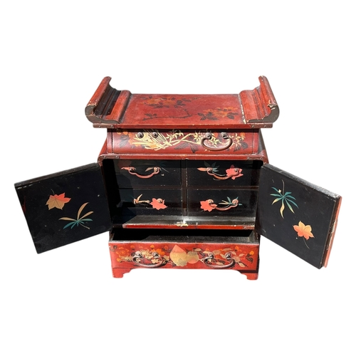 154 - A JAPANESE MEIJI RED LACQUERED TABLETOP TRINKET/JEWELLERY CABINET
Together with a Chinese red lacque... 