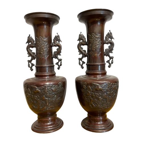 162 - A PAIR OF JAPANESE MEIJI BRONZE VASES
Both decorated with birds and peacocks amongst floral foliage,... 