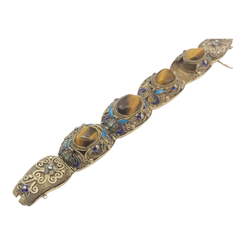 199 - A 20TH CENTURY SILVER FILIGREE, ENAMEL AND TIGERS EYE BRACELET
Hallmarked for Poland. 
(length 18cm,... 