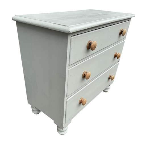 11 - A VICTORIAN PAINTED PINE CHEST OF THREE LONG DRAWERS
Fitted with knob handles, on squat turned legs.... 