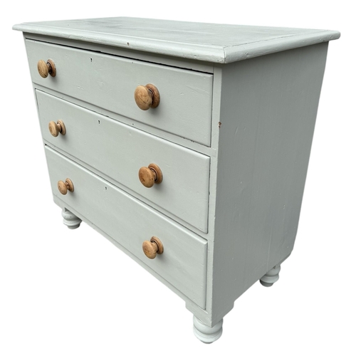 11 - A VICTORIAN PAINTED PINE CHEST OF THREE LONG DRAWERS
Fitted with knob handles, on squat turned legs.... 