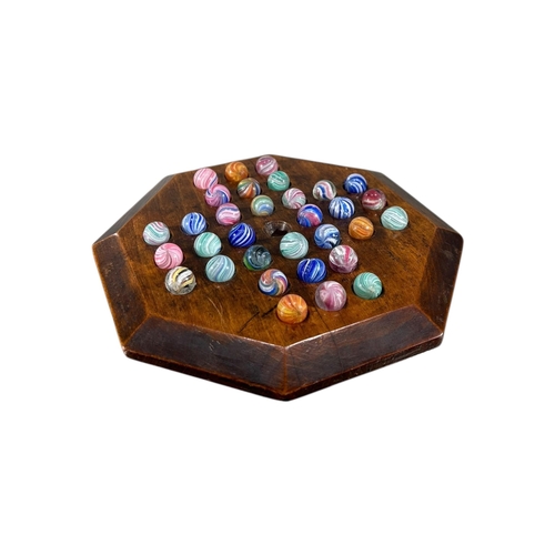 119 - A 19TH CENTURY VICTORIAN OCTAGONAL CARVED WOOD SOLITAIRE GAME
With thirty-two 19th Century glass mar... 