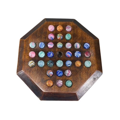 119 - A 19TH CENTURY VICTORIAN OCTAGONAL CARVED WOOD SOLITAIRE GAME
With thirty-two 19th Century glass mar... 