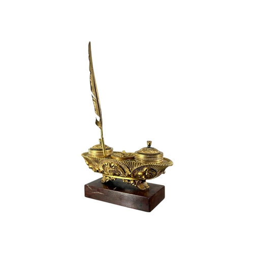 121 - A 19TH CENTURY FRENCH CHARLES X REGENCY GILT BRONZE AND MARBLE INKWELL
Ovular sarcophagus form with ... 