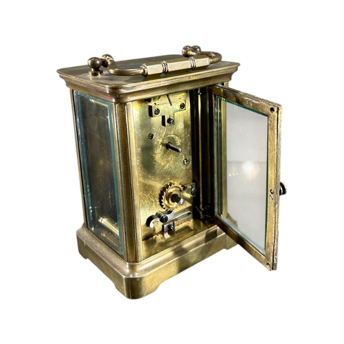 169 - A LATE 19TH/EARLY 20TH CENTURY FRENCH GILT BRASS CARRIAGE CLOCK
Having white enamel dial with black ... 