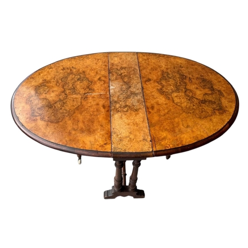 19 - A VICTORIAN FIGURED WALNUT OVAL SUTHERLAND TABLE
On turned legs and stretcher, along with a late Vic... 