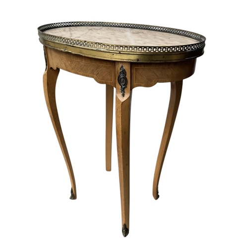 25 - A 19TH CENTURY STYLE FRENCH SIDE TABLE,
The oval marble top with pierced brass gallery above a singl... 