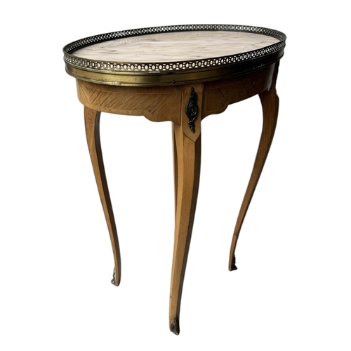 25 - A 19TH CENTURY STYLE FRENCH SIDE TABLE,
The oval marble top with pierced brass gallery above a singl... 