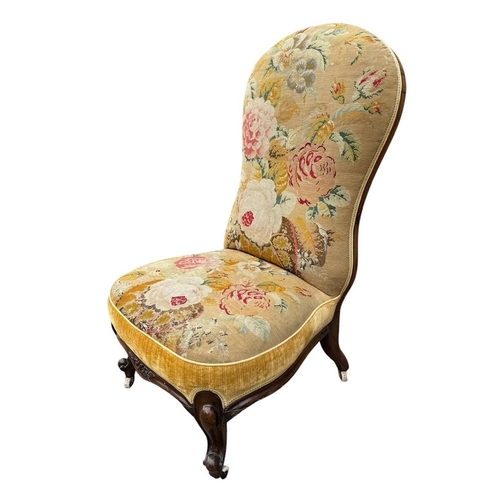 31 - A VICTORIAN SPOON BACK SIDE/NURSING CHAIR 
In a floral tapestry upholstery on squat cabriole legs wi... 