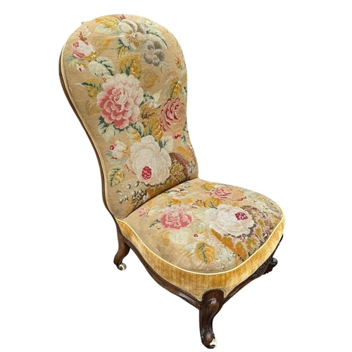 31 - A VICTORIAN SPOON BACK SIDE/NURSING CHAIR 
In a floral tapestry upholstery on squat cabriole legs wi... 