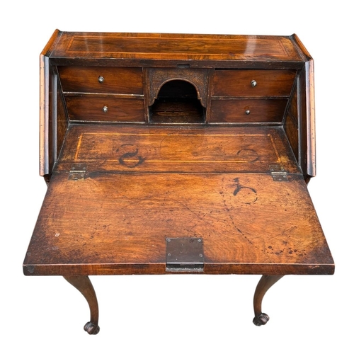 35 - AN EARLY 20TH CENTURY QUEEN ANNE STYLE  WALNUT AND INLAID FREESTANDING LADIES’ WRITING BUREAU
The fa... 