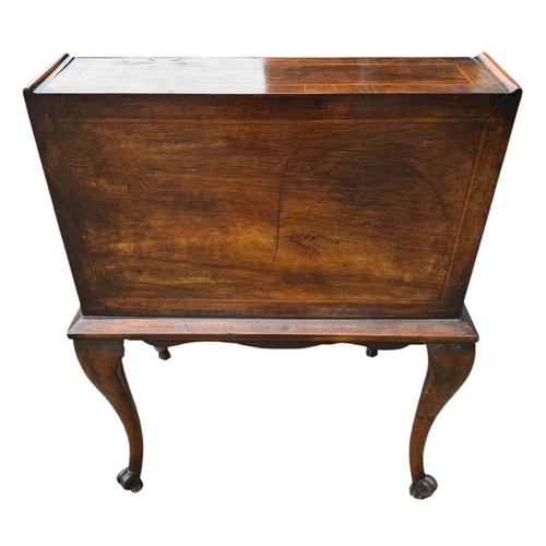 35 - AN EARLY 20TH CENTURY QUEEN ANNE STYLE  WALNUT AND INLAID FREESTANDING LADIES’ WRITING BUREAU
The fa... 