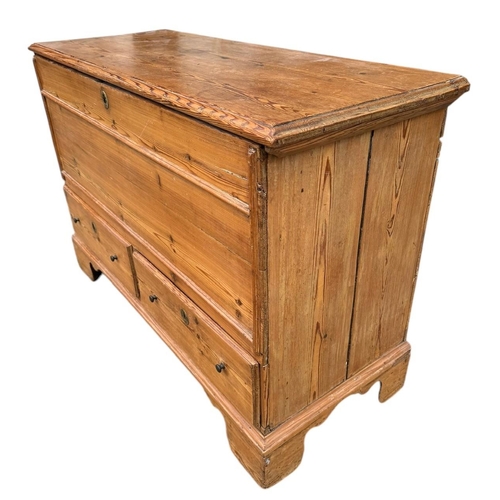 39 - AN EARLY 19TH CENTURY WAXED PINE MULE CHEST
With rise and fall top and two drawers, on bracket feet.... 