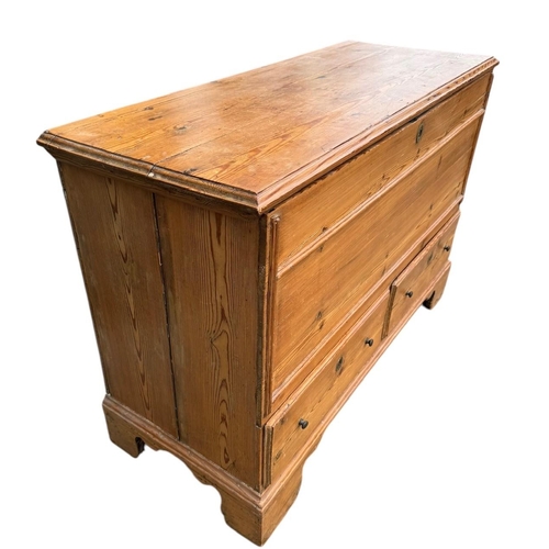 39 - AN EARLY 19TH CENTURY WAXED PINE MULE CHEST
With rise and fall top and two drawers, on bracket feet.... 