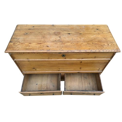 39 - AN EARLY 19TH CENTURY WAXED PINE MULE CHEST
With rise and fall top and two drawers, on bracket feet.... 