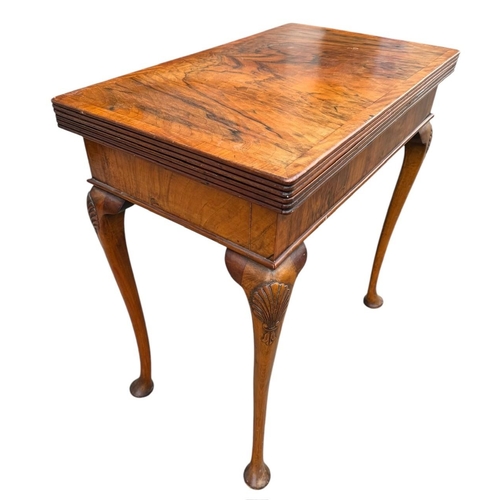 43 - A GEORGIAN STYLE WALNUT FOLD OVER CARD TABLE
The rectangular top enclosing a green baize playing sur... 