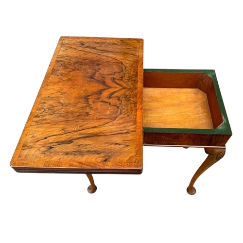 43 - A GEORGIAN STYLE WALNUT FOLD OVER CARD TABLE
The rectangular top enclosing a green baize playing sur... 