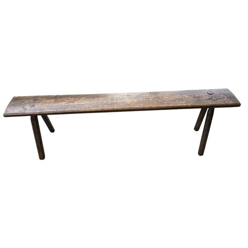 45 - A 19TH CENTURY FRENCH PROVINCIAL RUSTIC OAK BENCH
The single plank top on splayed chamfered legs.
(h... 