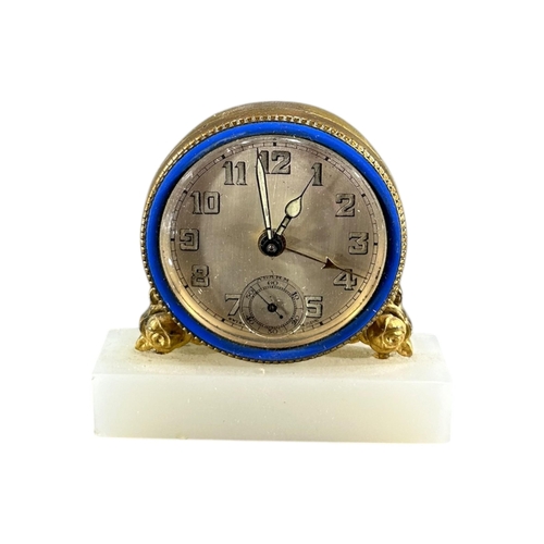 91 - BREVET, SWISS, A 20TH CENTURY ART DECO ENAMEL, ONYX AND GILT BRASS MINIATURE CLOCK
Having brushed si... 