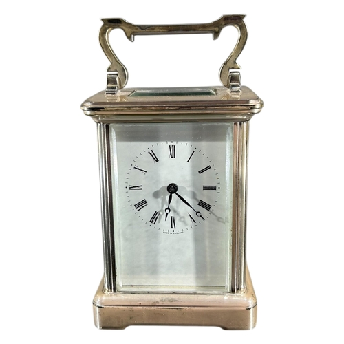 96 - A 20TH CENTURY ENGLISH SILVERED CARRIAGE CLOCK
Having white enamel dial with black Roman numerals. 
... 