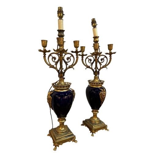 125 - A PAIR OF 19TH CENTURY FRENCH LOUIS XVI DESIGN GILT METAL COBALT BLUE PORCELAIN FOUR BRANCH CANDELAB... 