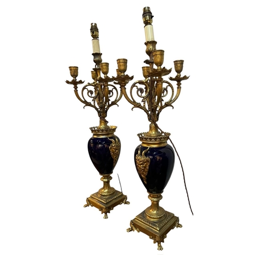 125 - A PAIR OF 19TH CENTURY FRENCH LOUIS XVI DESIGN GILT METAL COBALT BLUE PORCELAIN FOUR BRANCH CANDELAB... 