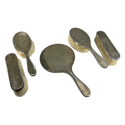 198A - A MID CENTURY SILVER FIVE PIECE VANITY SET
Hallmarked London, 1958, all having engine turned decorat... 