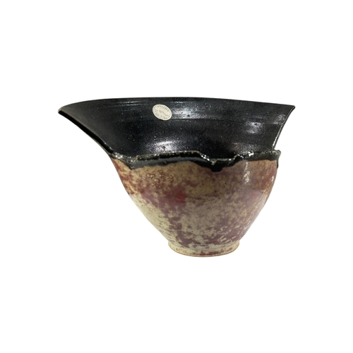 153A - A 20TH CENTURY ABSTRACT STUDIO POTTERY BOWL
Having mottled brown and black salt glaze, bearing old S... 