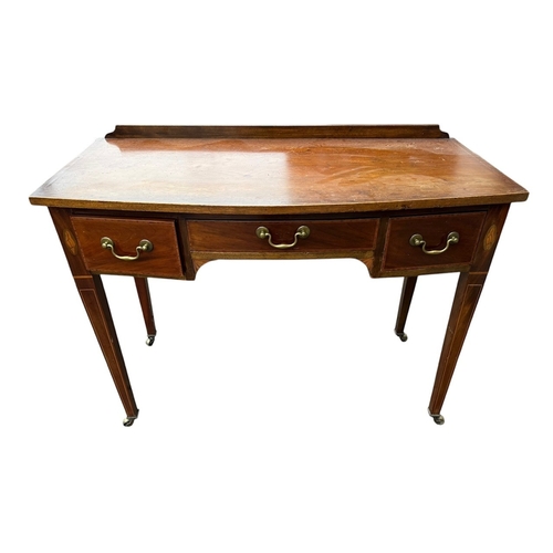 3A - A 19TH CENTURY MAHOGANY AND SHELL INLAY BOW FRONT SIDE TABLE
With three drawers, raised on square ta... 