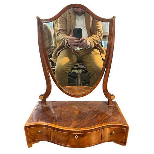 8A - A 19TH CENTURY MAHOGANY SHIELD DRESSING TABLE MIRROR
Supported on a serpentine base, with three draw... 